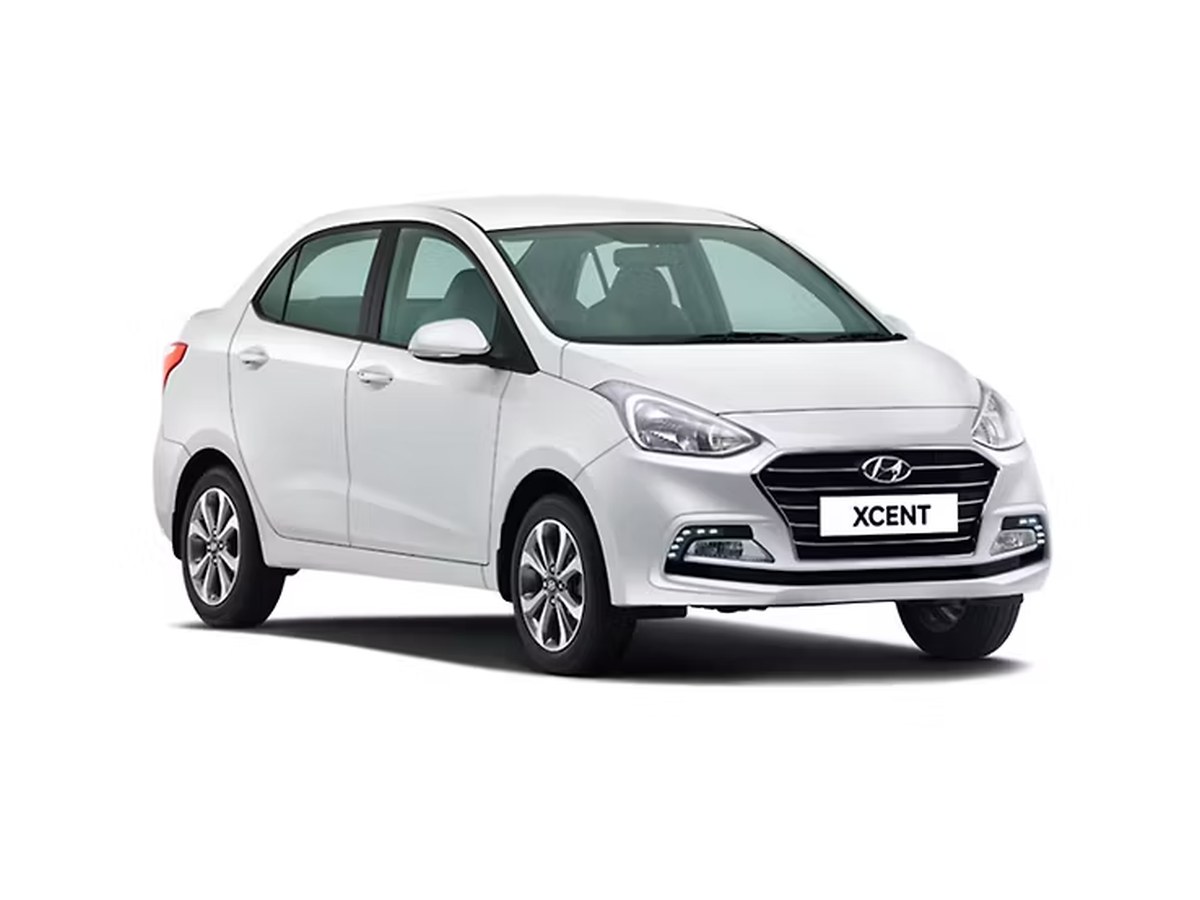 White sedan available on hire from Trapti Travels, Honnavar