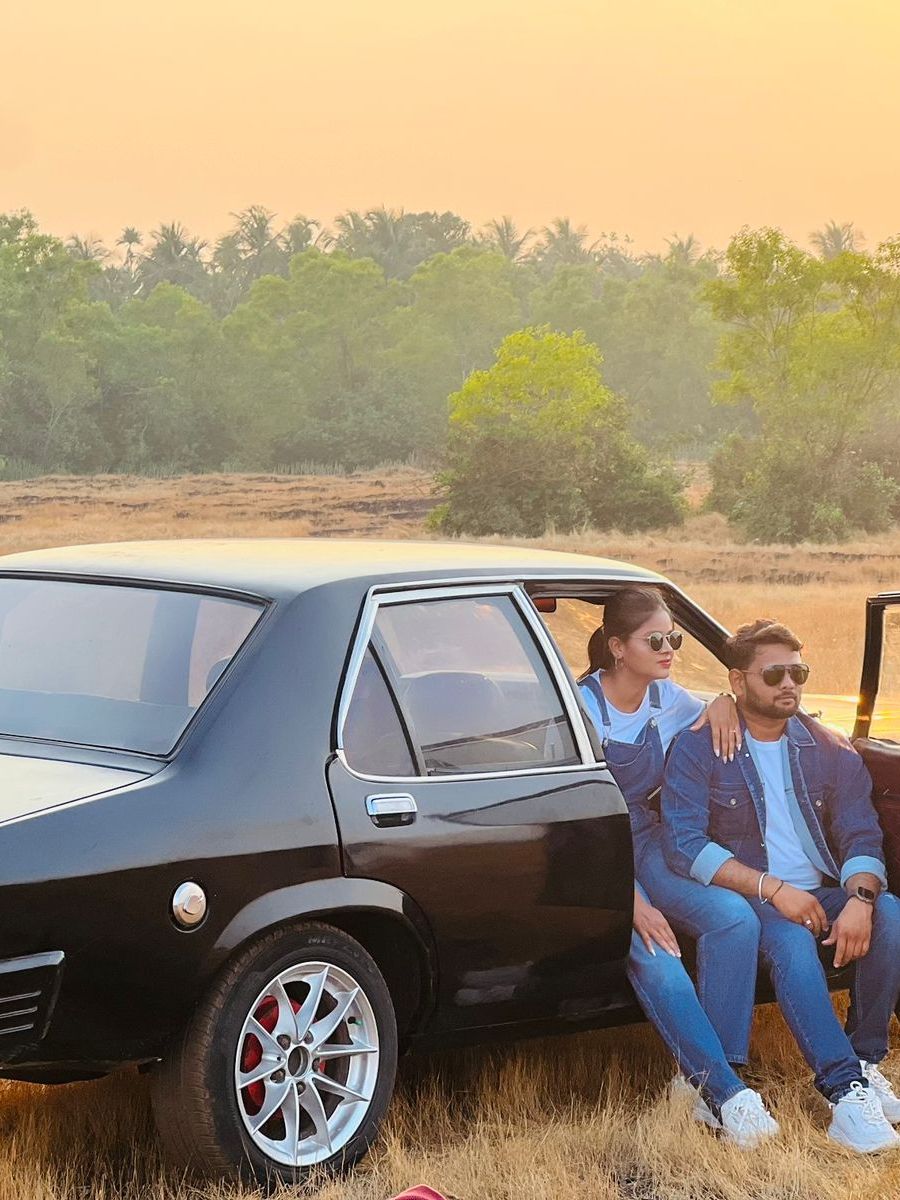 Couple beside the Contessa in a golden field