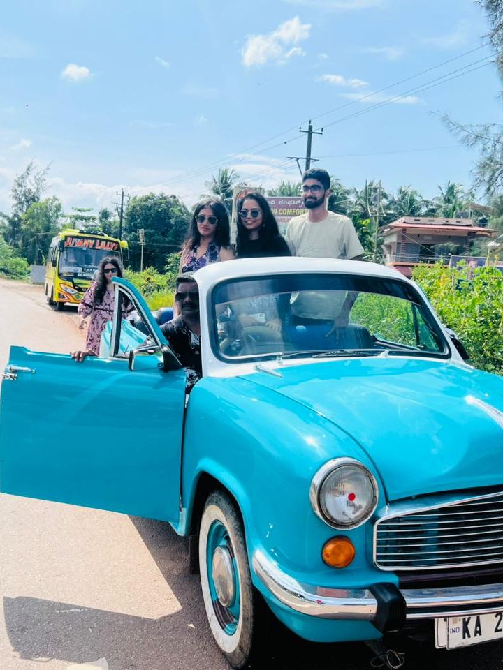 The open-top Ambassador on the coastal highway